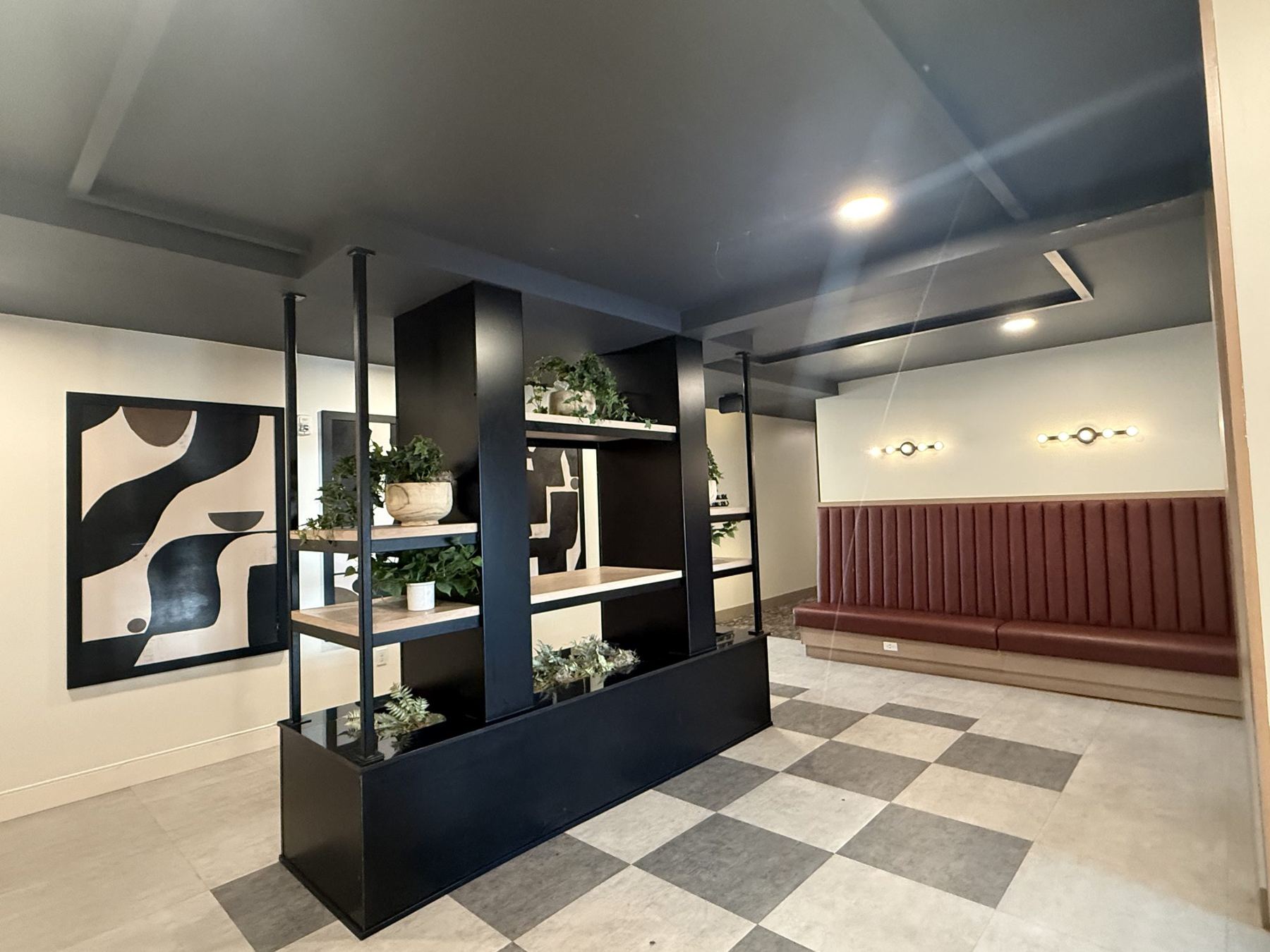 Clean apartment building lobby with wood-look flooring and lounge seating